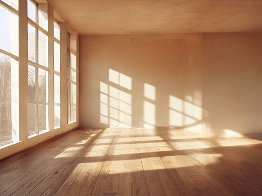 Sunlight streaming through tall windows in a bright movement studio space